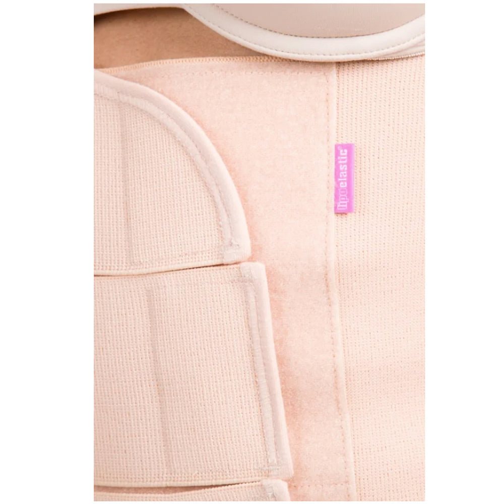 Close-up of Lipoelastic KPlus nude abdominal binder Velcro fastening with pink brand logo label detail.