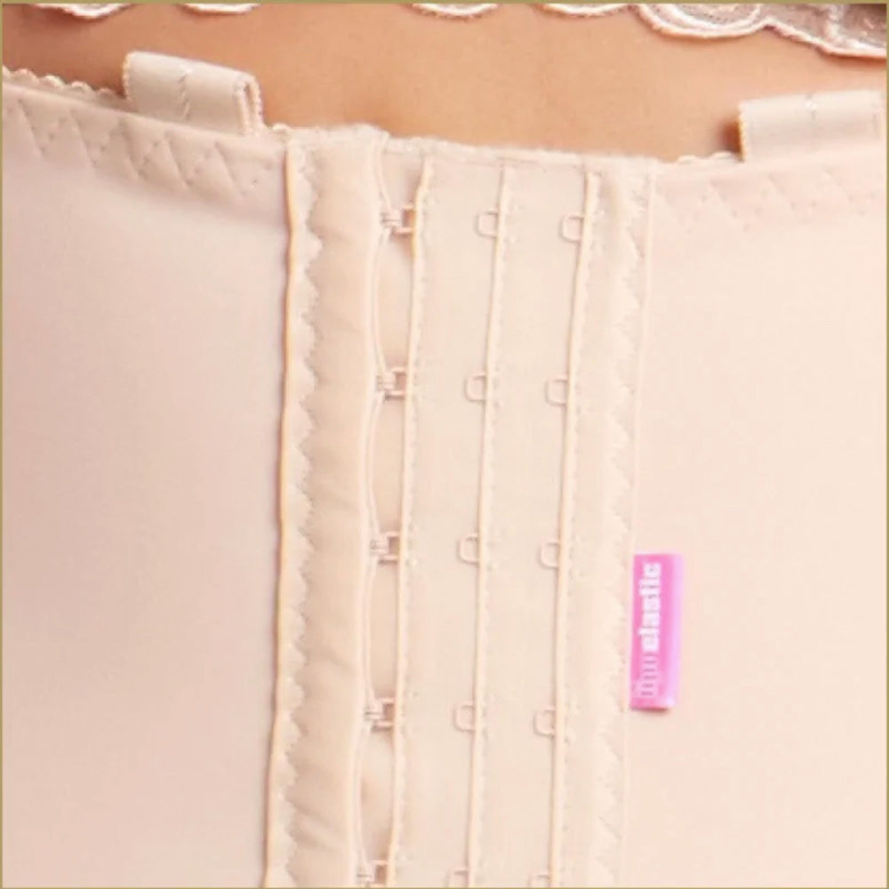 Close-up of Lipoelastic VF Variant nude compression girdle front hook-and-eye fastening with reinforced stitching.
